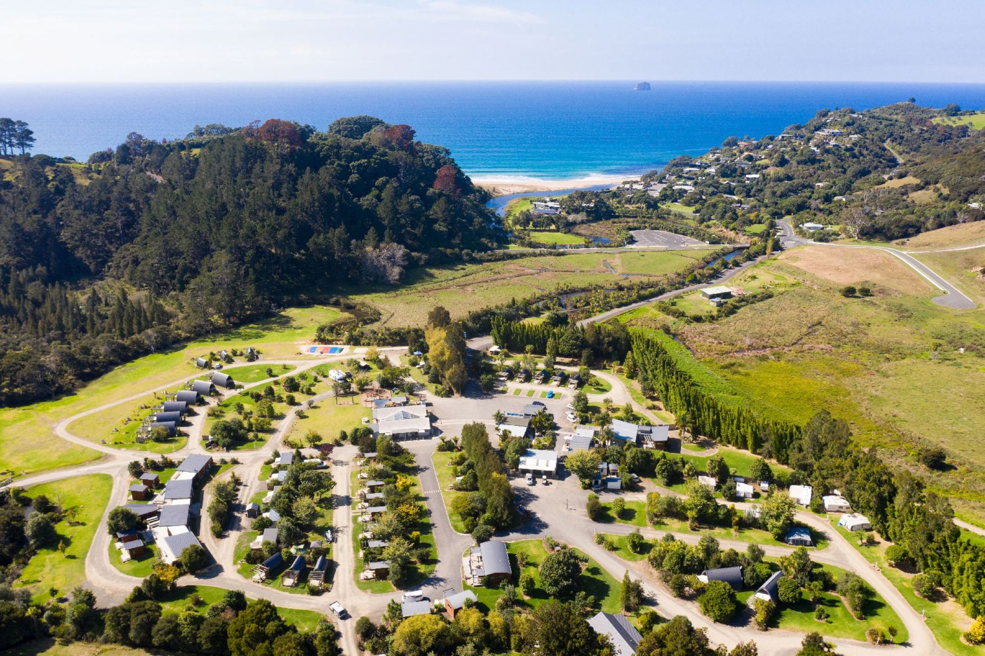 Aerial view of coastal cabins on a New Zealand headland